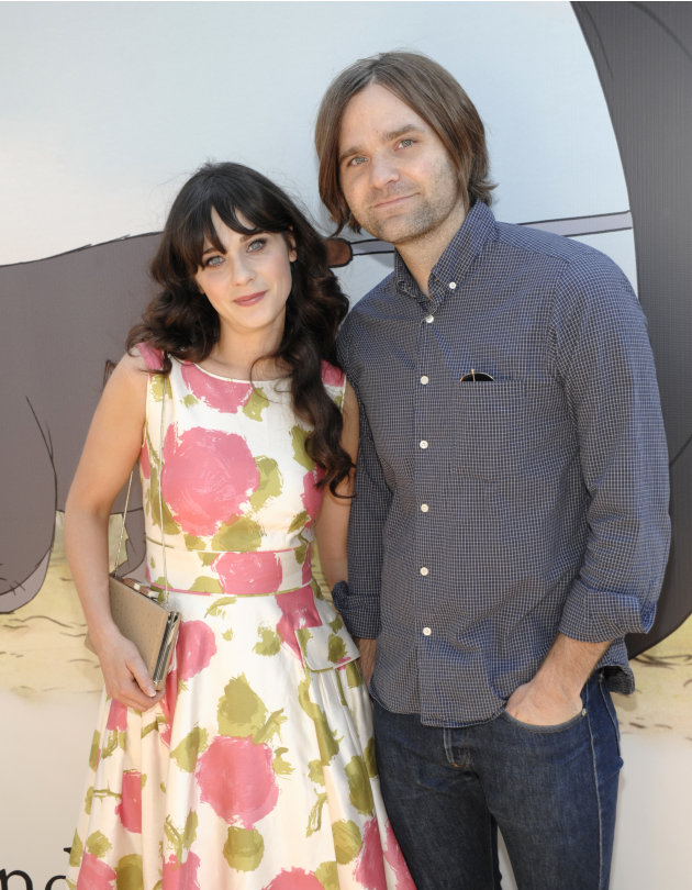 FILE - In this July 10, 2011 file photo, actress Zooey Deschanel, left, and her husband, musician Ben Gibbard arrive at the premiere of the animated feature film "Winnie the Pooh" at The Walt Disney S