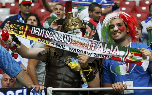 Soccer fans of Italy hold up a scarf before the start of the Euro 2012 semi-final soccer match between Italy and Germany at the National Stadium in Warsaw