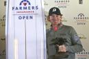 Brandt Snedeker holds the Framers Insurance Open trophy and a ceremonial surfboard after the final round of the Farmers Insurance Open golf tournament Monday, Feb. 1, 2016, in San Diego. Snedeker finished his final round Sunday before it was suspended because of inclement weather and did not have to play Monday. (AP Photo/Lenny Ignelzi)