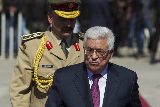 Palestinian President Abbas walks after laying a wreath in Ramallah