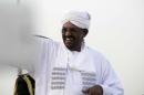 Sudanese President Omar al-Bashir waves as he arrives in Khartoum on June 15, 2015
