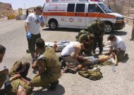 Wounded Israeli soldiers are treated at the site of a shooting attack along the border between Israel and Egypt, southern Israel, Thursday, Aug. 18, 2011. Assailants armed with heavy weapons, guns and explosives crossed into southern Israel from the neighboring Egyptian Sinai peninsula on Thursday, killing six Israelis and wounding at least a dozen more in an audacious string of attacks that stoked concerns about Palestinian militants exploiting the recent instability in Egypt. (AP Photo/Yosi Ben) ISRAEL OUT