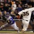 Colorado Rockies catcher Wilin Rosario, left, catches the relay from the outfield and tags out San Francisco Giants' Brandon Crawford, who was trying to score on a single from Angel Pagan, during the fifth inning of a baseball game on Monday, Sept. 17, 2012, in San Francisco. (AP Photo/Marcio Jose Sanchez)