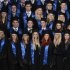 Students wearing hats pose for a group photoduring their graduation ceremony at the Hamburg School of Business Administration (HSBA) in Hamburg
