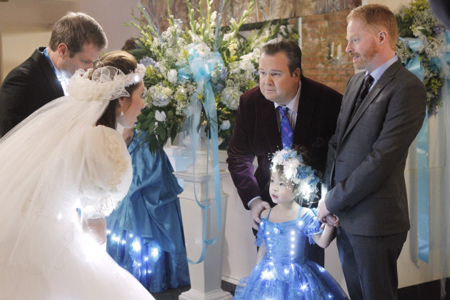 In this image released by ABC, from right, Jesse Tyler Ferguson portraying Mitchell Pritchett, and Eric Stonestreet portraying Cameron Tucker are shown with Aubrey Anderson-Emmons, who plays their adopted daughter Lily in a scene from "Modern Family," airing Wednesday, Jan. 18, 2012 at 9 p.m. EST on ABC. A group opposed to the use of profanity is protesting Wednesday's episode of "Modern Family," in which the character Lily is shown, but not heard, using an expletive. (AP Photo/ABC, Peter "Hopper" Stone)