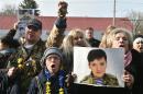 Protesters hold a portrait of the hunger-striking Ukrainian pilot Nadiya Savchenko at a rally supporting her outside the Russian embassy in Kiev on March 6, 2016