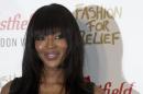 British supermodel Naomi Campbell poses as she arrives at the launch of the Fashion For Relief Pop-Up at Westfield in London on November 27, 2014