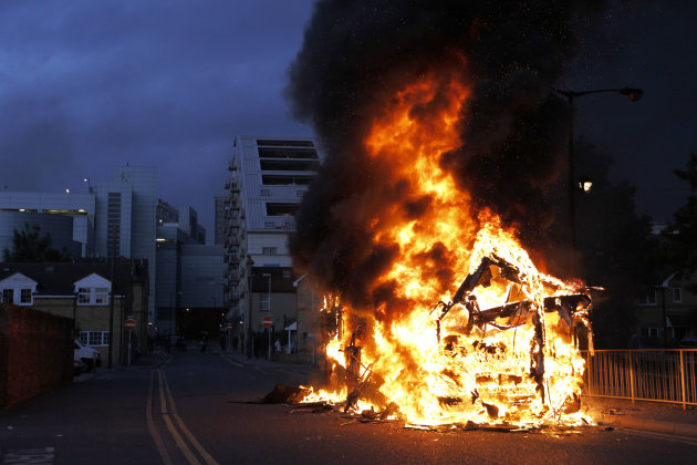 A bus is set on fire as rioters gathered in Croydon, south London, Monday, Aug. 8, 2011. Violence and looting spread across some of London's most impoverished neighborhoods on Monday, with youths setting fire to shops and vehicles, during a third day of rioting in the city that will host next summer's Olympic Games. (AP Photo/Sang Tan)