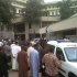 This image released by Saharareporters shows ambulances and rescue workers after a large explosion struck the United Nations' main office, background, in Nigeria's capital Abuja Friday Aug. 26, 2011, flattening one wing of the building and killing several people. A U.N. official in Geneva called it a bomb attack. The building, located in the same neighborhood as the U.S. embassy and other diplomatic posts in Abuja, had a huge hole punched in it.   (AP Photo/Saharareporters)