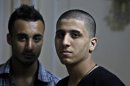 Ayman al-Sayed, 19, right, with his hair cut, and his friend Mohammed Hanouna, 18, left, pose for photo during an interview in Gaza City, Sunday, April 7, 2013. Al-Sayed used to have shoulder-length hair but says he was grabbed by Hamas police in a sweep along with other young men with long or gel-styled spiky hair last week, and that police shaved everyone's head. Hanouna still wears the hair-style that can now get young men in trouble in Gaza, during the Islamic militants latest attempt to impose their hardline version of Islam on Gaza. (AP Photo/Adel Hana)