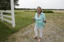 In this Aug. 1, 2014 photo, Louise Danzig, of Montauk, N.Y., stands in a field in East Hampton, N.Y., that is home to deer that may carry ticks that cause people to develop allergic reactions to red meat. Danzig landed in the hospital last summer after a tick bite caused her to go into anaphylactic shock from eating a hamburger. (AP Photo/Rachelle Blidner)