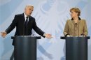 French Prime Minister Ayrault and German Chancellor Merkel address a joint news conference at the Chancellery in Berlin