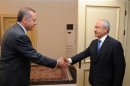 Turkish PM Erdogan shakes hands with main opposition leader Kilicdaroglu in Ankara