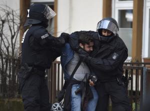 German riot police detain a photographer near the European …