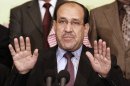 FILE - In this Friday, March 26, 2010, file photo Iraqi Prime Minister Nouri al- Maliki speaks to the press in Baghdad, Iraq. Al- Maliki threatened Wednesday to call early elections that could tighten his grip on power if the nation's political factions fail to break an impasse that has all but paralyzed the government. (AP Photo/Hadi Mizban, File)