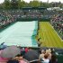 Ground staff pull on the protective rain covers on No 2 Court  at the All England Tennis Club in Wimbledon, London