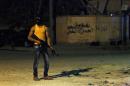 A masked Libyan gunman stands on a street in the eastern city of Benghazi, early on July 29, 2014, as violence flares