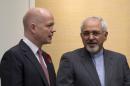 British Foreign Secretary William Hague speaks with Iranian Foreign Minister Mohammad Javad Zari during a meeting on Iran nuclear talks in Geneva