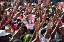 Supporters of the PHTK political party hold posters of presidential candidate Jovenel Moise during a protest near headquarters of the Provisional Electoral Council (CEP) in Port-au-Prince on April 24, 2016 and demand that elections to be held