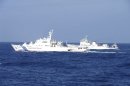 Chinese marine surveillance ship Haijian No. 51 cruises next to a Japan Coast Guard patrol ship in the East China Sea