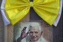 An image of Pope Benedict XVI is taped to a wall, topped with a Vatican-colored bow, in Leon, Mexico, Thursday March 22, 2012. It's been a decade since the former Pope John Paul Paul II visited Mexico; his fifth and final trip to the country. His successor, Benedict, arrives Friday. The Pope will hold Sunday Mass in Silao, Mexico, against the backdrop of the 60-foot-tall hilltop statue of Christ the King, before leaving for Cuba on Monday. (AP Photo/Eduardo Verdugo)