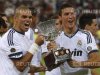 Real Madrid's players Pepe and Cristiano Ronaldo celebrate with the trophy after winning their Spanish Super Cup second leg soccer match against Barcelona at the Santiago Bernabeu stadium in Madrid