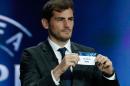 File - In this Aug. 28, 2014 file photo, Real Madrid goalkeeper Iker Casillas shows the name of Porto during a UEFA Champions League draw at the Grimaldi Forum, in Monaco. Casillas is leaving Real Madrid to join Portuguese club FC Porto after 16 seasons in which he helped the Spanish powerhouse win three Champions League titles, five Spanish leagues and two Copas del Rey. (AP Photo/Claude Paris, File)