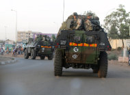 FILE - In this Jan. 15, 2013 file photo, French troops in two armored personnel carriers drive through Mali's capital Bamako on the road to Mopti. The Obama administration has declared it cannot accept new terrorist sanctuaries in   Mali or anywhere else and has promised to support French and African efforts to restore security. Yet after almost a year of disorder in the West African nation, Washington is still keeping the conflict at arm's length. (AP Photo/Jerome Delay, File)