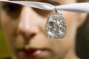 FILE - In this May 2, 2012 file photo an employee shows the Beau Sancy diamond, 34.98 carat, at Sotheby's auction house in Zurich, Switzerland. Marie de Medici wore it at her coronation as Queen Consort of Henry IV in 1610, and now the Beau Sancy diamond is a lavish accessory owned by an anonymous bidder who paid US $9.7 million (7.6 million euro) for it at Sotheby’s auction in Geneva Tuesday May 15, 2012. The spring auction season for jewelry and watches is upon Geneva, where elegant lakefront hotels fill with well-heeled buyers and bidders in a scene far removed from the debate over European austerity. (AP Photo / Keystone, Alessandro Della Bella, File)