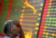 <p> A stock investor reacts near a board displaying stock prices at a brokerage house in Huaibei in central China's Anhui province Monday June 24, 2013. Global stock markets reeled Monday, with Shanghai's index enduring its biggest loss in four years, after China allowed commercial lending rates to soar in a move analysts said was aimed at curbing a booming underground lending industry. (AP Photo) CHINA OUT