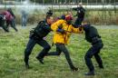 French police try to stop migrants on the Eurotunnel site in Coquelles near Calais, northern France, on July 29, 2015