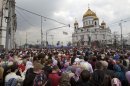 Russian Orthodox belivers pray outside the Christ the Savior Cathedral in Moscow, Russia, Sunday, April 22, 2012. Thousands have gathered at Moscow's main cathedral to pray for the defense of the Russian Orthodox Church. Patriarch Kirill called on worshippers at Sunday's service to pray 