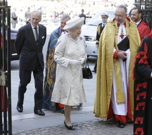 Britain's Queen Elizabeth II and her husband Prince Philip, left, arrive for service to celebrate the Queen's 60th anniversary of her coronation at Westminster Abbey, escorted by The Dean of the Abbey Dr John Hall in London, Tuesday, June 4, 2013. (AP Photo/Alastair Grant)