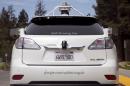 The rear of a Lexus SUV equipped with Google self-driving sensors is seen during a media preview of Google's prototype autonomous vehicles in Mountain View, California