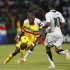 Mali's Samba Diakite challenges Ghana's Dede Ayew during their African Nations Cup Group D soccer match in Franceville Stadium
