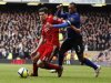 Liverpool's Kelly and Manchester United's Evra compete for the ball duringduring their English FA Cup fourth round soccer match in Liverpool