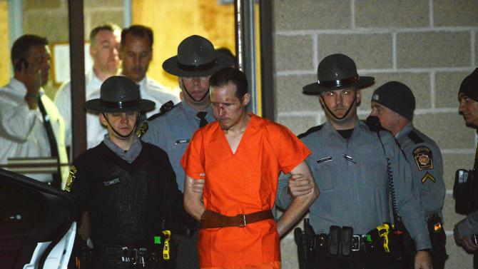 State troopers escort Eric Matthew Frein from the Blooming Grove barracks early Friday Oct. 31, 2014. Frein, accused of opening fire on the barracks Sept. 12, killing state police Cpl. Bryon K. Dickson II and critically wounding Trooper Alex T. Douglass, was arrested Thursday night after a 48-day manhunt in the Pike and Monroe County woods. (AP Photo/The Scranton Times & Tribune, Jason Farmer)