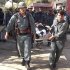 Afghan policemen carry the body of a civilian after a bomb blast in Faryab province