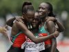 Kenya's gold medalist Edna Ngeringwony Kiplagat, right, embraces teammates and silver medalist Priscah Jeptoo, left, and bronze medalist Sharon Jemutai Cherop following the Women's Marathon at the World Track and Field Championships in Daegu, South Korea, Saturday, Aug. 27, 2011. (AP Photo/Kevin Frayer)