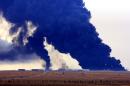 Heavy black smoke rises from an oil facility in northern Libya's Ras Lanouf region on January 23, 2016, after it caught fire following attacks launched by Islamic State group jihadists