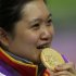 China's Guo Wenjun bites her gold medal at the victory ceremony for the women's 10m Air Pistol competition at the London 2012 Olympic Games