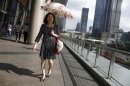 Woman walks with her pet dog at Lujiazui financial district of Pudong in Shanghai