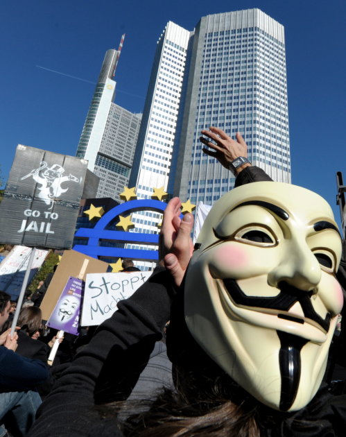 Protestors with masks and banners  gather in front of the European Central Bank headquarters in Frankfurt, central Germany, during a demonstration to support the ' Occupy Wallstreet' movement  Saturda