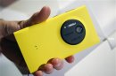 A man displays Nokia's new smartphone, the Lumia 1020 with a 41-megapixel camera, during its unveiling in New York