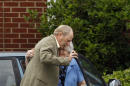 Two people embrace as they arrive to a funeral service for Cooper Harris at the University Church of Christ on Saturday, June 28, 2014, in Tuscaloosa, Ala. Cooper Harris, 22 months old, died in Georgia on June 18 after he was left in his fathers' SUV for seven hours. (AP Photo/Butch Dill)
