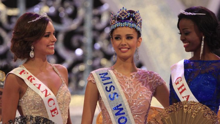 Newly crowned Miss World, Megan Young of Philippines, center, with second runner-up Miss France Marine Lorpheline, left, and third runner-up Miss Ghana Carranza Naa Okailey Shooter, smile after they winning the Miss World contest in Nusa Dua, Bali, Indonesia, Saturday, Sept. 28, 2013. (AP Photo/Firdia Lisnawati)