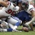 Indianapolis Colts quarterback Kerry Collins, bottom center, fumbles the snap as Houston Texans defensive end J.J. Watt (99) tackles him in the first quarter of an NFL football game Sunday, Sept. 11, 2011, in Houston. Watt recovered the fumble. (AP Photo/David J. Phillip)