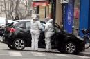 In this Wednesday, Jan. 7, 2015, file photo, forensic experts examine the car believed to have been used as the escape vehicle by gunmen who attacked the French satirical newspaper Charlie Hebdo's office, in Paris. One week since the unleashing of the lethal Paris terror attacks, investigators on Wednesday Jan. 14, 2015, are still unraveling the complex, overlapping contacts among the perpetrators and their suspected accomplices in an intricate piece of detective work ranging from the Paris suburbs to the Balkans and Turkish-Syrian border. (AP Photo / FILE)