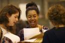 Students react as they receive their A- level results at the Harris City Academy in London