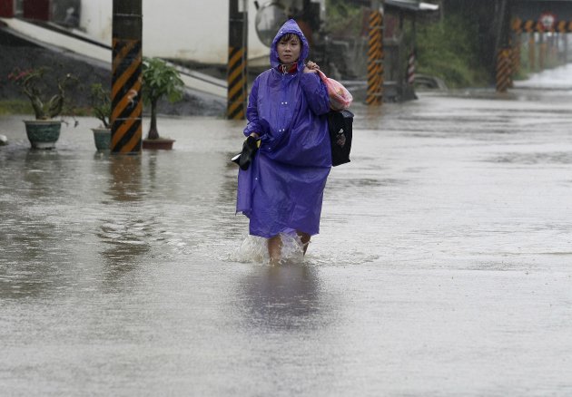 Woman walks in floods caused by Typhoon Nanmadol in Chiangyuan, Pingtung County, southern Taiwan